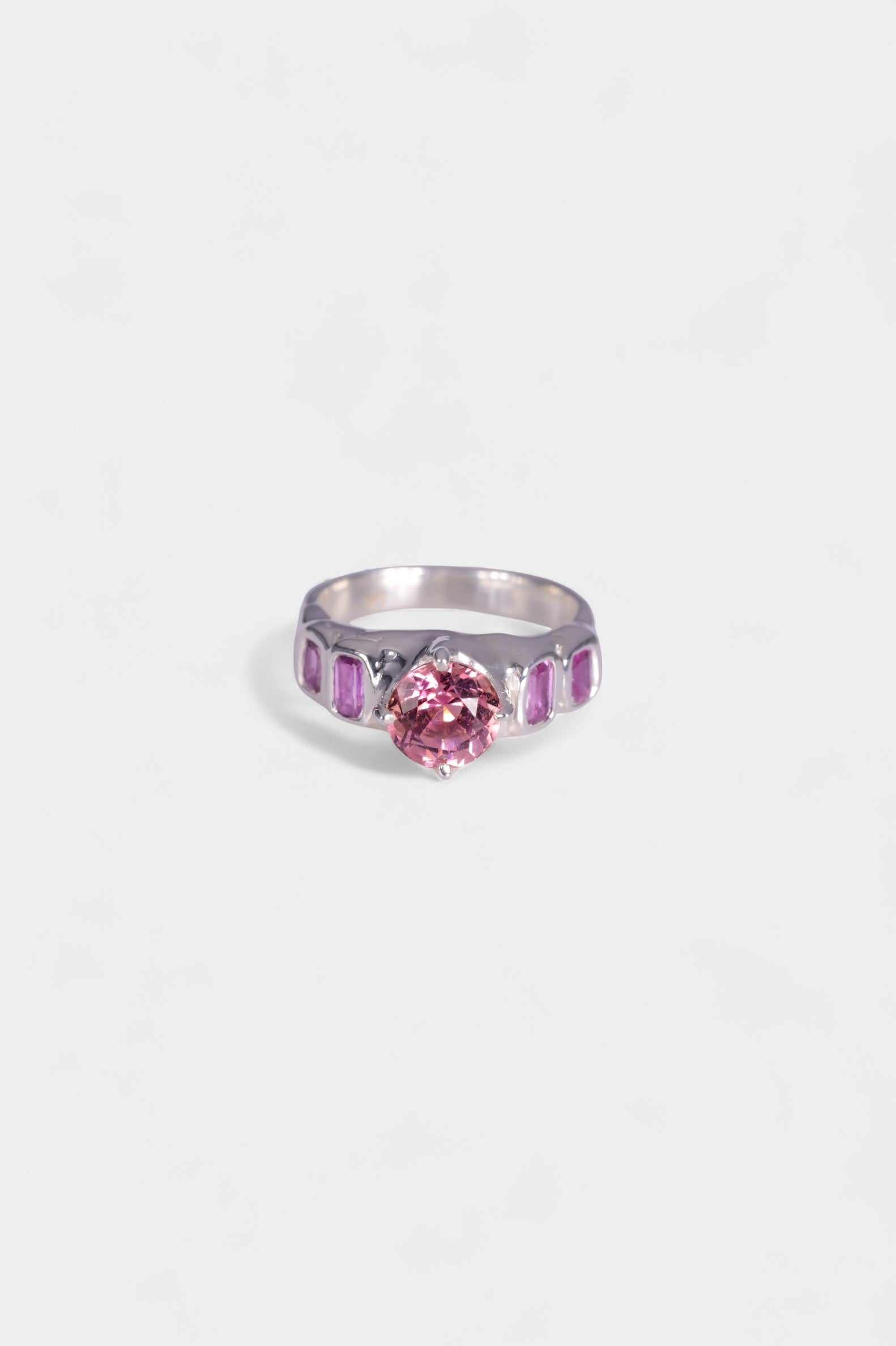 Pink Juice Ring
sterling silver
~ 8mm round cut pink tourmaline
~ two 4.5x3mm emerald cut purple sapphire
~ two 3.5x3mm emerald cut purple sapphire