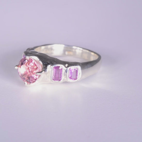 Pink Juice Ring
sterling silver
~ 8mm round cut pink tourmaline
~ two 4.5x3mm emerald cut purple sapphire
~ two 3.5x3mm emerald cut purple sapphire